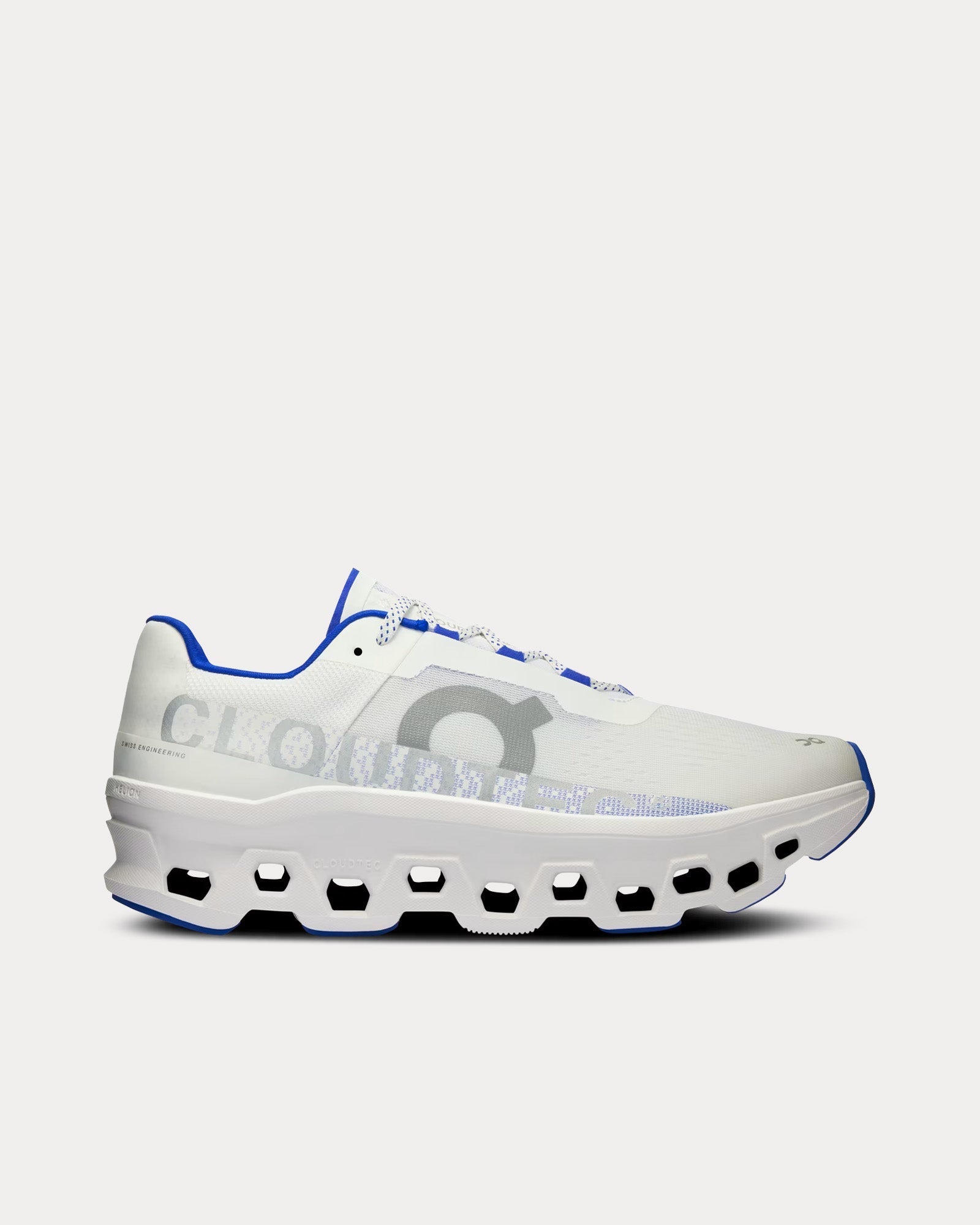 Side view on white background of Mens On Cloudmonster running shoe in White/Indigo, Medium (Regular) width