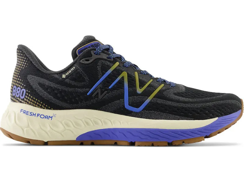 Side view on white background of Womens New Balance Fresh Foam X 880v12 GTX running shoe in Black/Marine Blue, Medium (Regular) width