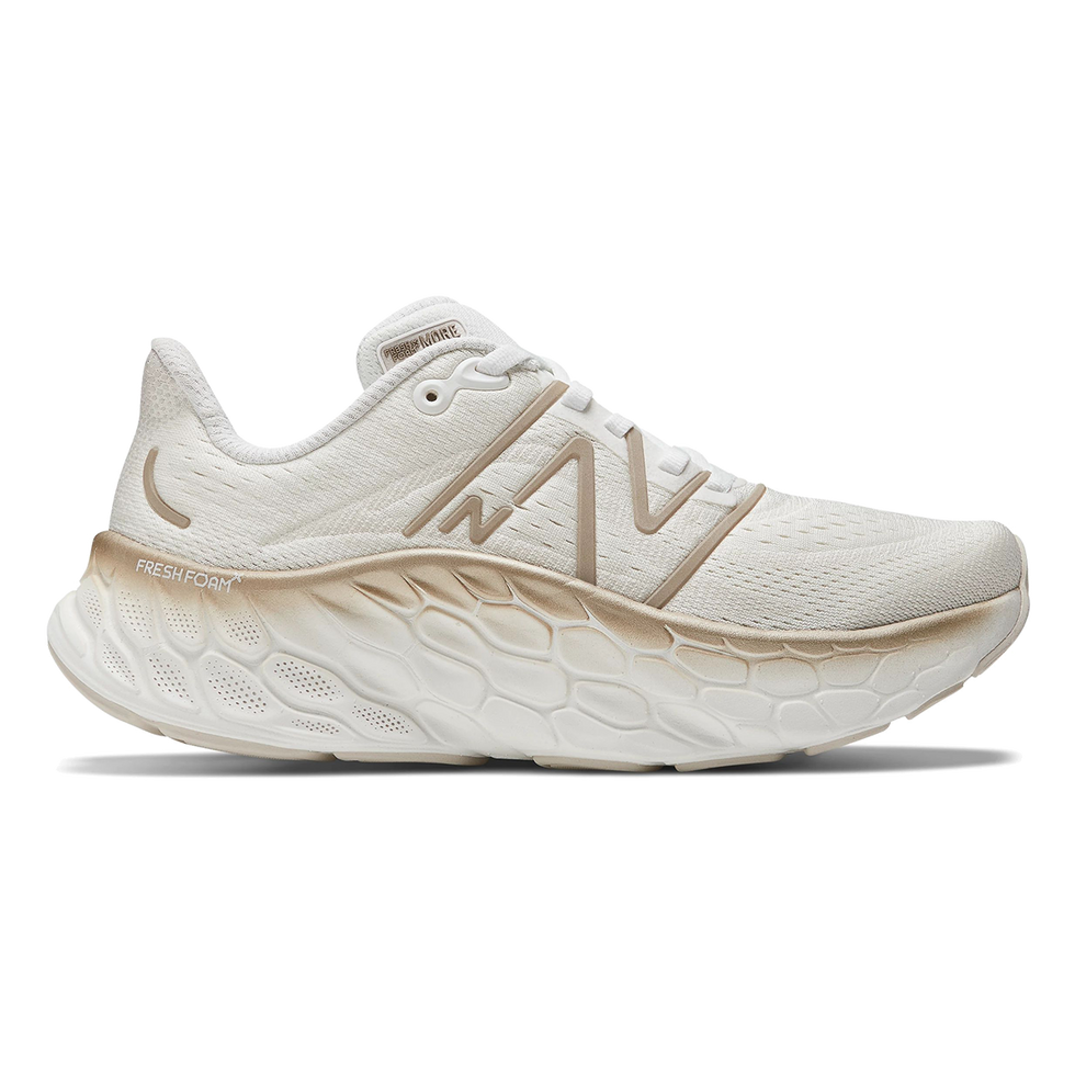 Side view on white background of Womens New Balance Fresh Foam X More v4 running shoe in White/Gold Metallic/Moonbeam, Wide width
